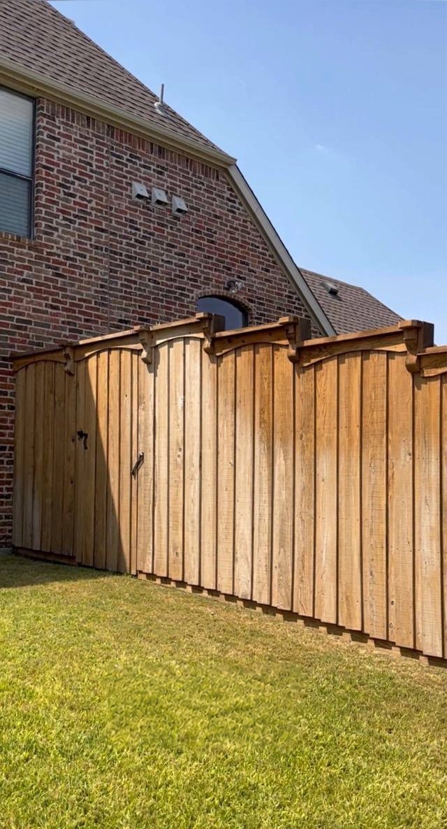 Cedar fence before: faded, weathered wood