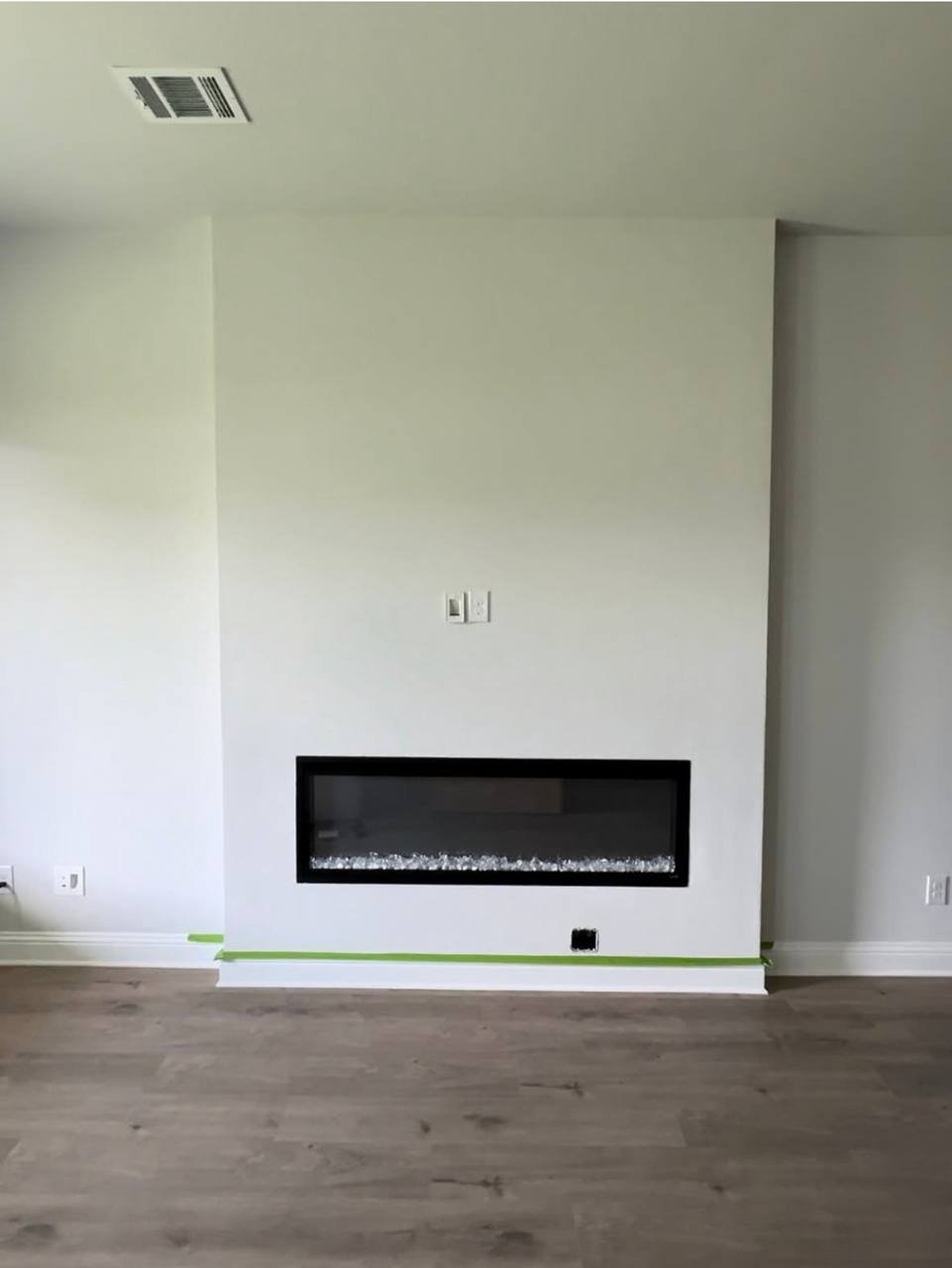 Fireplace wall before: plain white