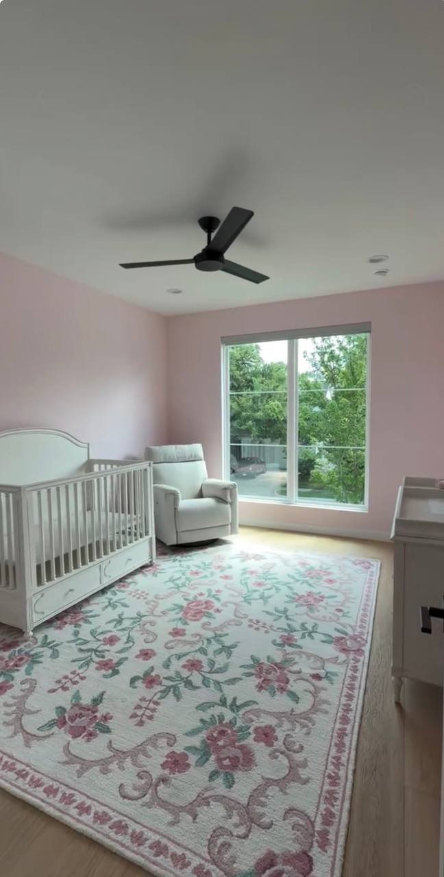 Nursery after: blush pink walls and white trim